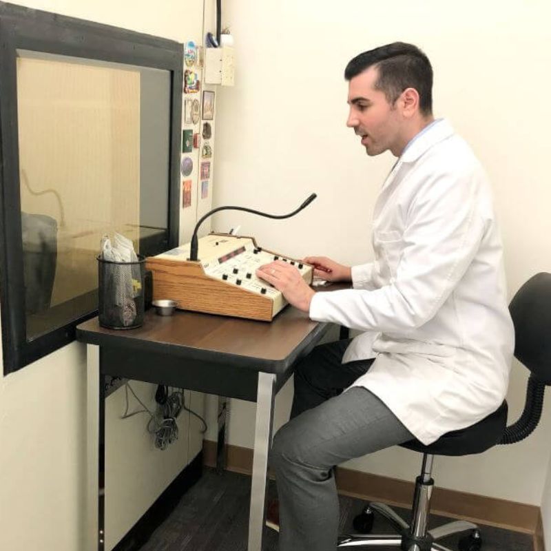 audiologist conducting a hearing test